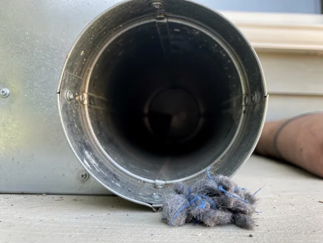 Ipswich Dryer Vent Cleaning technician using specialized equipment to clear severe dryer vent blockage in Ipswich